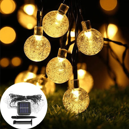 Warm white globe lights with solar panel and stake